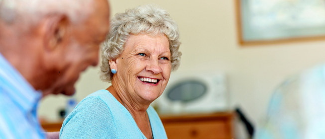 A senior woman smiling with a senior friend 